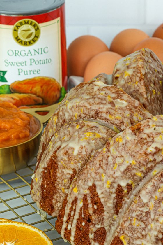 side view of sweet potato bundt cake with an orange glaze