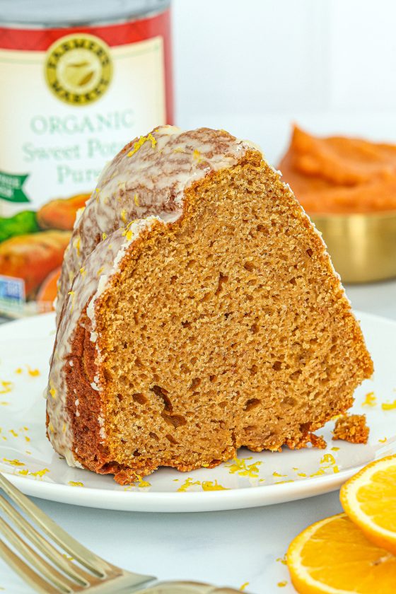 a slice of sweet potato bundt cake with an orange glaze made with Farmer's Market Foods Organic Sweet Potato Puree
